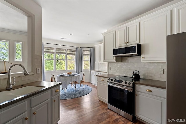 3401 Coles Point Way Unit A, Henrico, VA 23060 - kitchen with stainless steel appliances, a sink, dark countertops, backsplash, and dark wood-style flooring