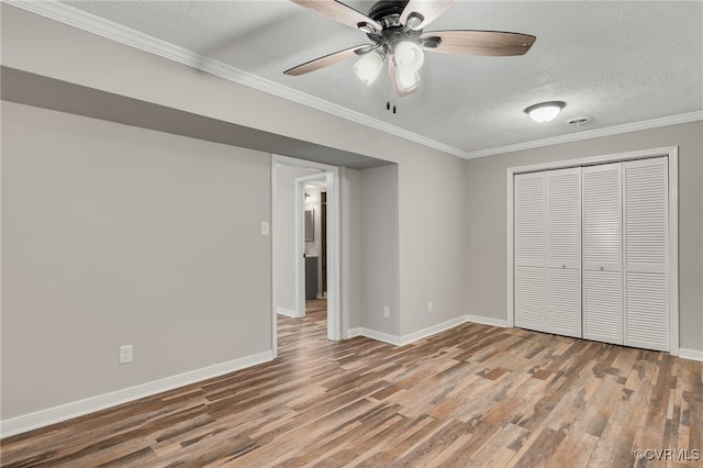 3411 Sylvania Rd, Chester, VA 23831 - unfurnished bedroom with wood finished floors, a textured ceiling, baseboards, crown molding, and a closet