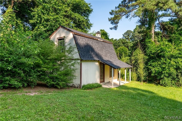 3411 Sylvania Rd, Chester, VA 23831 - rear view of house with a gambrel roof, a shingled roof, a yard, an outbuilding, and a chimney