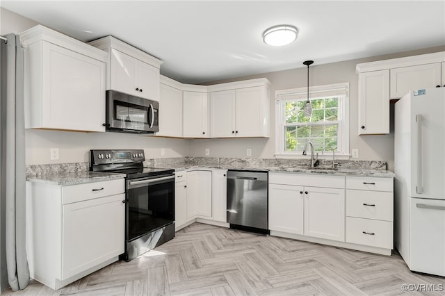 3411 Sylvania Rd, Chester, VA 23831 - kitchen featuring appliances with stainless steel finishes, a sink, white cabinets, light stone counters, and decorative light fixtures