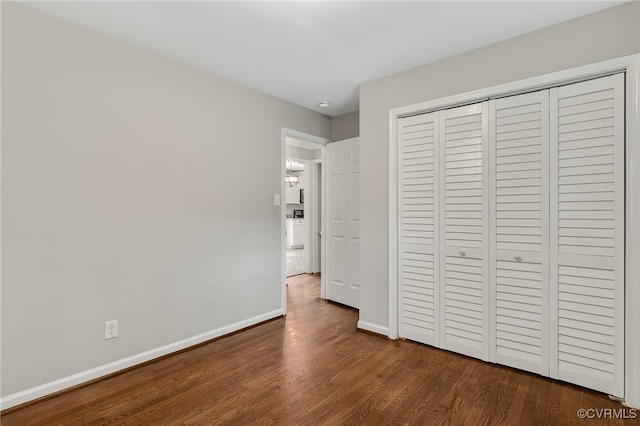 3411 Sylvania Rd, Chester, VA 23831 - unfurnished bedroom with dark wood finished floors, baseboards, and a closet