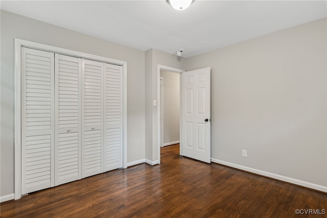3411 Sylvania Rd, Chester, VA 23831 - unfurnished bedroom with dark wood finished floors, baseboards, and a closet