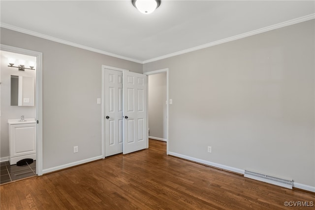 3411 Sylvania Rd, Chester, VA 23831 - unfurnished bedroom featuring wood finished floors, ornamental molding, baseboards, a sink, and ensuite bath