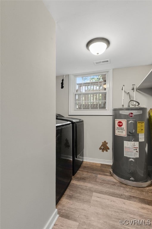 3411 Sylvania Rd, Chester, VA 23831 - laundry room featuring electric water heater, independent washer and dryer, wood finished floors, and baseboards