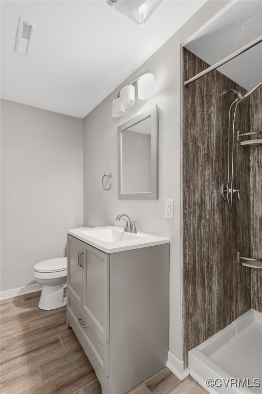3411 Sylvania Rd, Chester, VA 23831 - full bath with toilet, vanity, a shower, wood finished floors, and baseboards