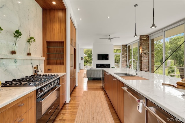 912 S Gaskins Rd, Henrico, VA 23238 - kitchen with high end range, stainless steel dishwasher, a sink, light wood-style floors, and modern cabinets