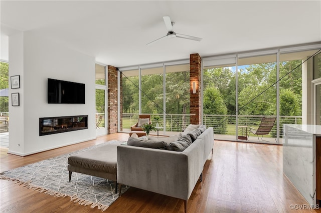 912 S Gaskins Rd, Henrico, VA 23238 - living room with a wall of windows, a ceiling fan, wood finished floors, and a glass covered fireplace