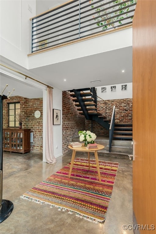 912 S Gaskins Rd, Henrico, VA 23238 - lobby with brick wall, stairs, and a high ceiling