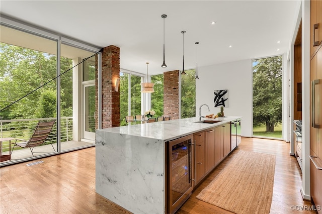912 S Gaskins Rd, Henrico, VA 23238 - kitchen featuring beverage cooler, floor to ceiling windows, a sink, modern cabinets, and a spacious island