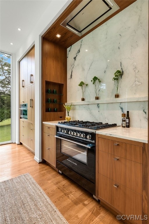912 S Gaskins Rd, Henrico, VA 23238 - kitchen with high end stove, light wood-style flooring, light countertops, recessed lighting, and modern cabinets