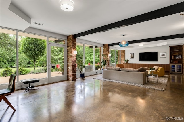 912 S Gaskins Rd, Henrico, VA 23238 - living room with healthy amount of natural light, concrete flooring, beam ceiling, wainscoting, and wooden walls