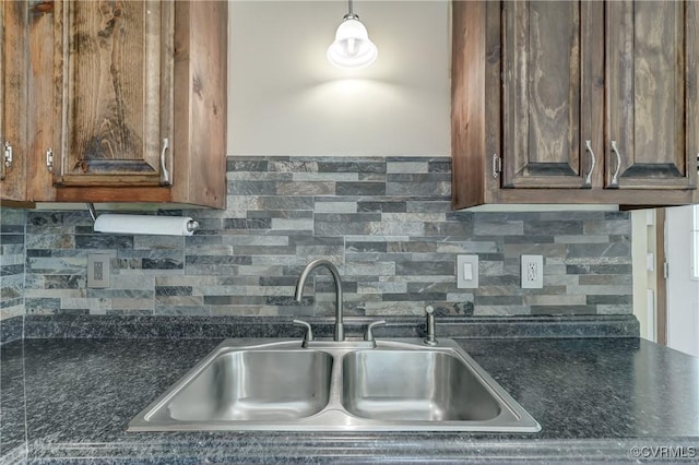 4509 Lockin Rd, Powhatan, VA 23139 - kitchen with a sink, backsplash, dark brown cabinetry, and pendant lighting