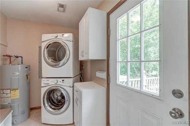 4509 Lockin Rd, Powhatan, VA 23139 - washroom featuring estacked washer and dryer, cabinet space, electric water heater, and light tile patterned floors