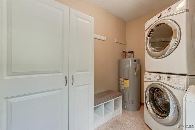 4509 Lockin Rd, Powhatan, VA 23139 - laundry room featuring electric water heater, stacked washer and clothes dryer, and light tile patterned floors