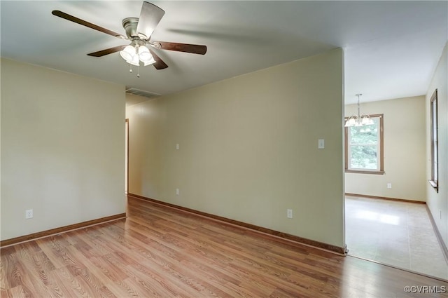 4509 Lockin Rd, Powhatan, VA 23139 - empty room with a chandelier, light wood-type flooring, a ceiling fan, and baseboards