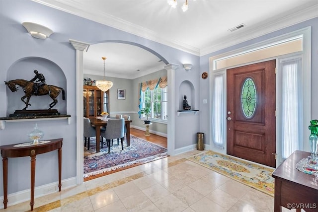 311 Victoria Way, Richmond, VA 23238 - foyer with arched walkways, a chandelier, ornate columns, crown molding, and baseboards