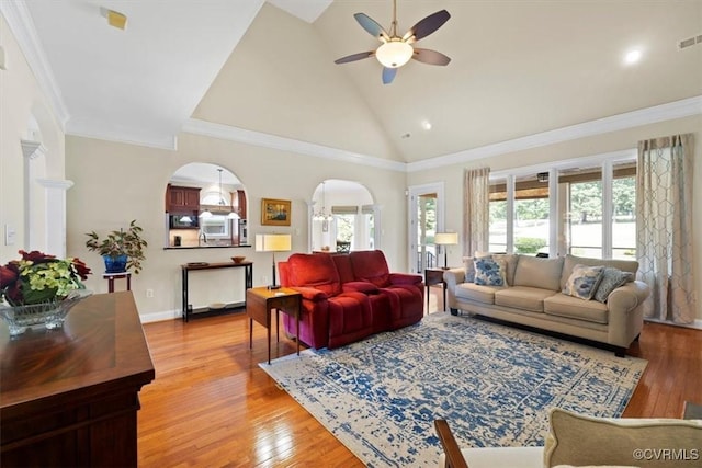 403 Regina Ln, Richmond, VA 23238 - living room with healthy amount of natural light, a ceiling fan, arched walkways, light wood-style flooring, and crown molding