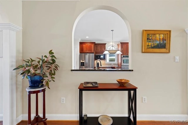 403 Regina Ln, Richmond, VA 23238 - corridor with arched walkways, recessed lighting, a sink, and wood finished floors