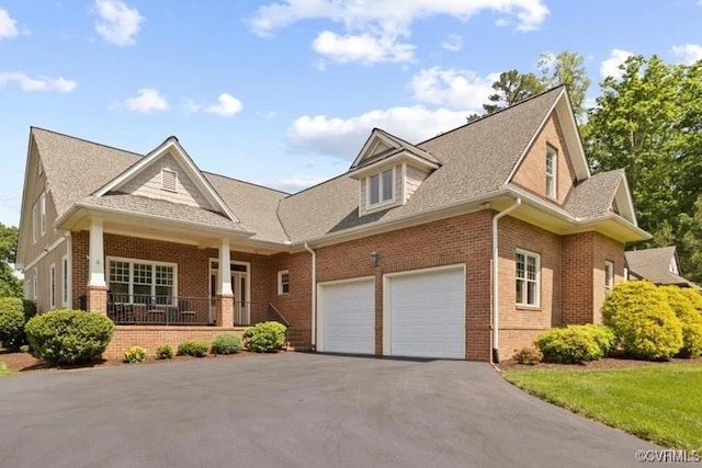 403 Regina Ln, Richmond, VA 23238 - view of front of house featuring brick siding, driveway, covered porch, roof with shingles, and a garage