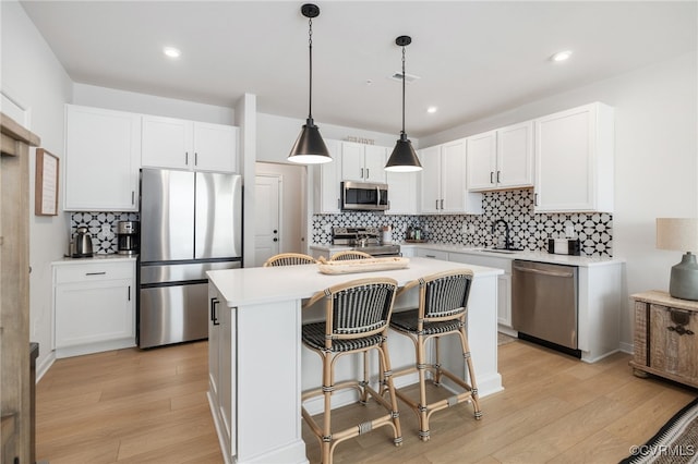 1900 Roseneath Rd Unit 8B, Richmond, VA 23230 - kitchen with appliances with stainless steel finishes, light wood-type flooring, tasteful backsplash, light countertops, and recessed lighting