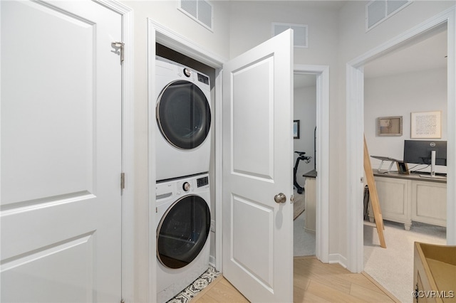 1900 Roseneath Rd Unit 8B, Richmond, VA 23230 - laundry area featuring stacked washer / drying machine and light wood-style flooring