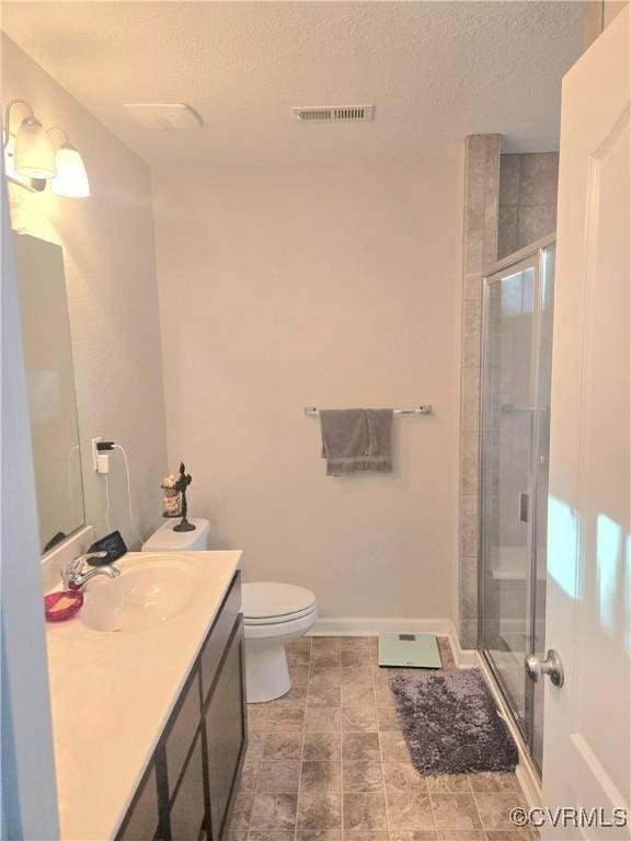705 Prosperity Ct Unit 705, Williamsburg, VA 23188 - bathroom with a textured ceiling, vanity, a shower stall, toilet, and baseboards
