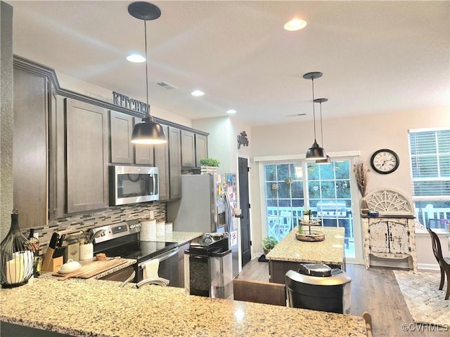 705 Prosperity Ct Unit 705, Williamsburg, VA 23188 - kitchen with appliances with stainless steel finishes, decorative backsplash, light stone countertops, wood finished floors, and recessed lighting