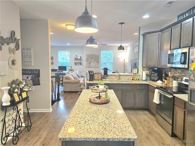 705 Prosperity Ct Unit 705, Williamsburg, VA 23188 - kitchen featuring appliances with stainless steel finishes, a sink, backsplash, light stone counters, and recessed lighting
