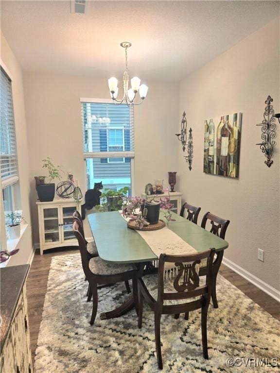 705 Prosperity Ct Unit 705, Williamsburg, VA 23188 - dining space featuring a chandelier, dark wood-style floors, and baseboards