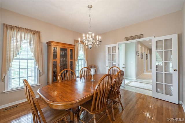 16180 Janet Dr, Amelia Courthouse, VA 23002 - dining space with french doors, a chandelier, baseboards, and light wood-type flooring