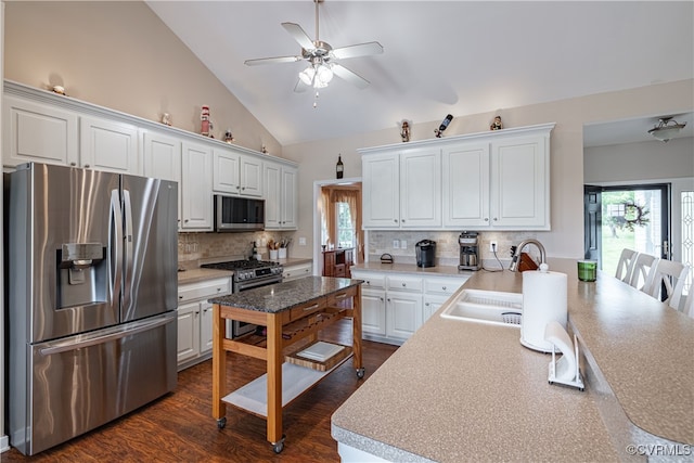16180 Janet Dr, Amelia Courthouse, VA 23002 - kitchen with stainless steel appliances, a sink, ceiling fan, white cabinetry, and high vaulted ceiling