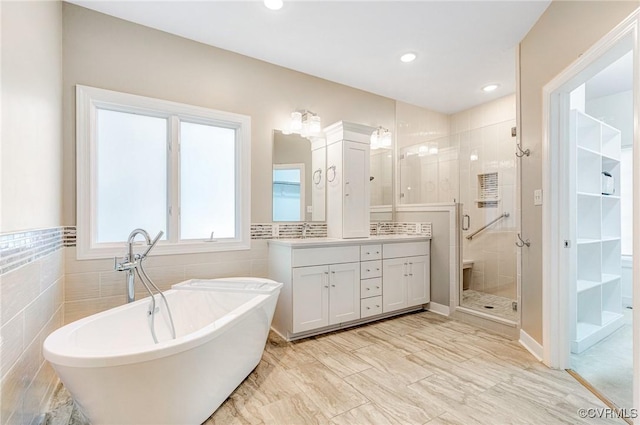 5605 Hunters Glen Dr, Glen Allen, VA 23059 - full bathroom featuring vanity, a shower stall, a freestanding bath, tile walls, and recessed lighting