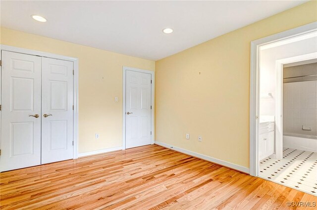 5605 Hunters Glen Dr, Glen Allen, VA 23059 - unfurnished bedroom with light wood finished floors, a closet, baseboards, recessed lighting, and connected bathroom