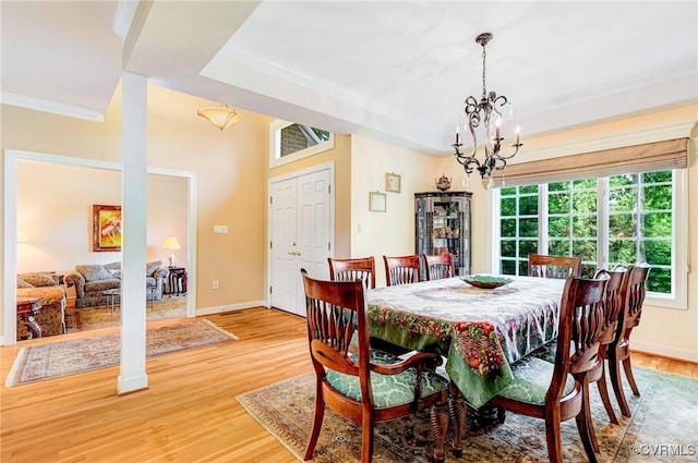 5605 Hunters Glen Dr, Glen Allen, VA 23059 - dining space featuring ornamental molding, a chandelier, light wood-style floors, and baseboards