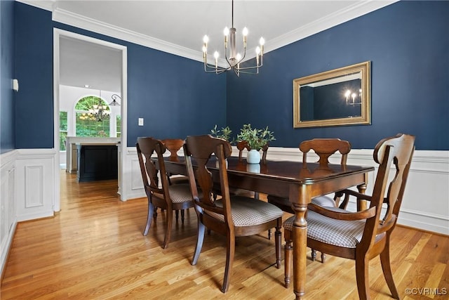 11137 Sterling Cove Dr, Chesterfield, VA 23838 - dining space with light wood-type flooring, a chandelier, wainscoting, crown molding, and a decorative wall