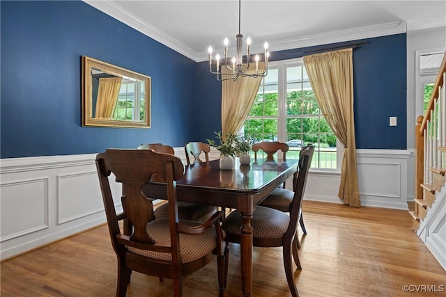11137 Sterling Cove Dr, Chesterfield, VA 23838 - dining room featuring a chandelier, a decorative wall, crown molding, light wood finished floors, and a wainscoted wall