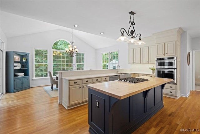 11137 Sterling Cove Dr, Chesterfield, VA 23838 - kitchen featuring butcher block counters, a chandelier, appliances with stainless steel finishes, vaulted ceiling, and light wood-style floors