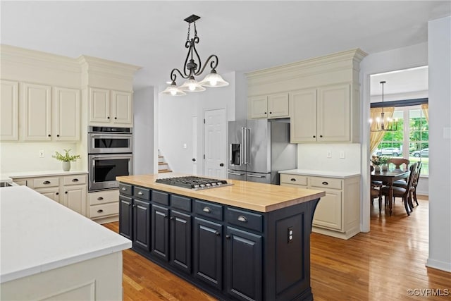 11137 Sterling Cove Dr, Chesterfield, VA 23838 - kitchen featuring appliances with stainless steel finishes, a chandelier, light wood-style flooring, decorative light fixtures, and a center island