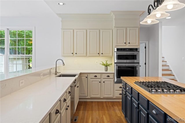 11137 Sterling Cove Dr, Chesterfield, VA 23838 - kitchen featuring a sink, appliances with stainless steel finishes, butcher block countertops, light wood-type flooring, and pendant lighting