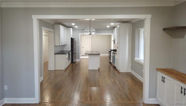 1118 27th, Richmond, VA 23223 - kitchen featuring dark wood-style flooring, a chandelier, white cabinetry, a kitchen island, and baseboards
