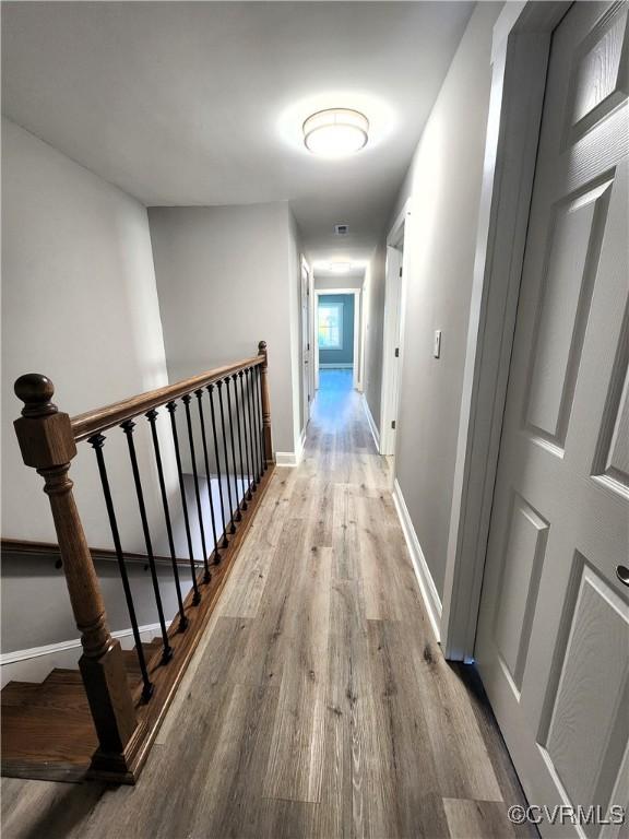1118 27th, Richmond, VA 23223 - hallway with wood finished floors, baseboards, and an upstairs landing