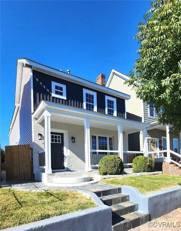 1118 27th, Richmond, VA 23223 - view of front of house featuring a porch, a chimney, and board and batten siding