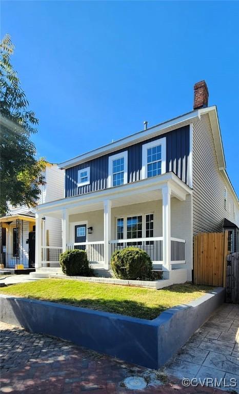 1118 27th, Richmond, VA 23223 - view of front of home with board and batten siding, a porch, and a chimney