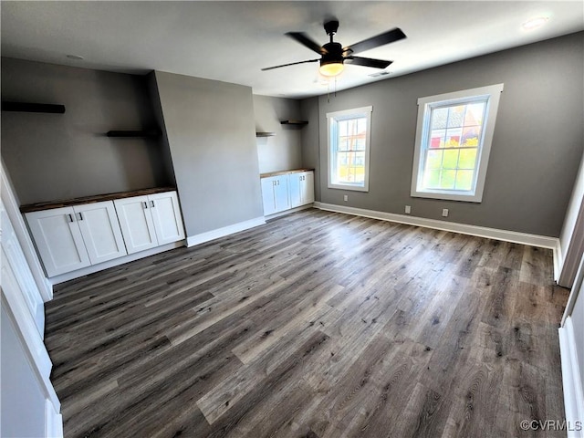 1118 27th, Richmond, VA 23223 - unfurnished living room featuring dark wood-style flooring, ceiling fan, and baseboards