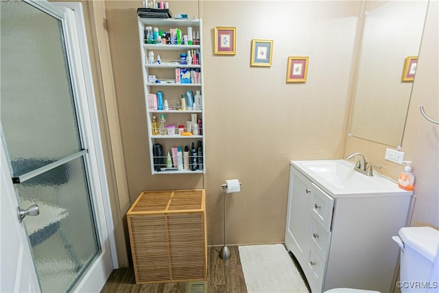 19083 Country Rd, Beaverdam, VA 23015 - bathroom featuring toilet, vanity, a shower with door, wood finished floors, and heating unit