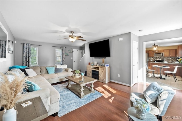 7012 Autumn Point Dr, North Chesterfield, VA 23234 - living area with a ceiling fan, light wood-style flooring, and baseboards