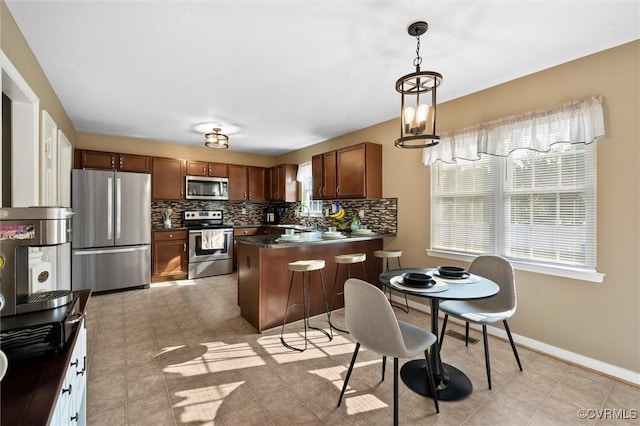 7012 Autumn Point Dr, North Chesterfield, VA 23234 - kitchen featuring stainless steel appliances, healthy amount of natural light, a peninsula, and dark countertops