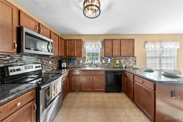 7012 Autumn Point Dr, North Chesterfield, VA 23234 - kitchen with appliances with stainless steel finishes, a sink, a peninsula, decorative backsplash, and brown cabinets