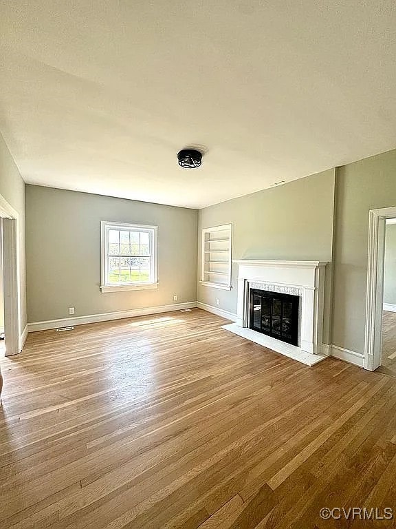 226 Purdy Rd, Emporia, VA 23847 - unfurnished living room with wood finished floors, a premium fireplace, and baseboards