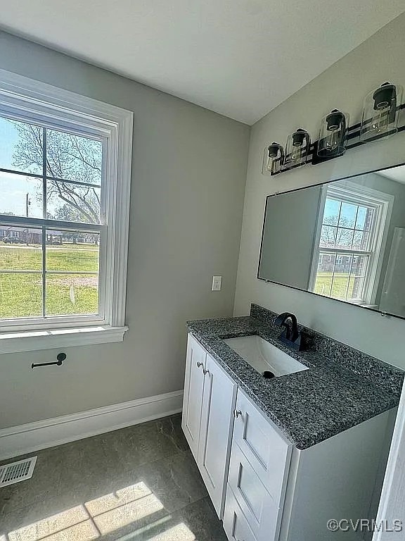 226 Purdy Rd, Emporia, VA 23847 - bathroom with baseboards, healthy amount of natural light, vanity, and marble finish flooring